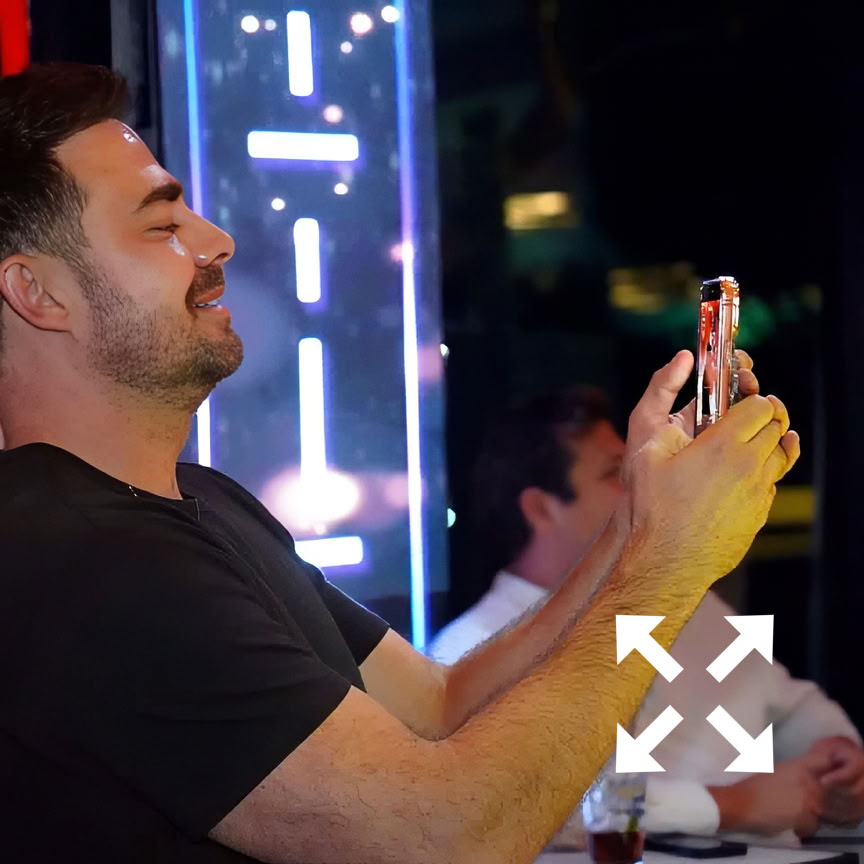 Elegant restaurant setting with a giant wall screen and a casual veranda setting.